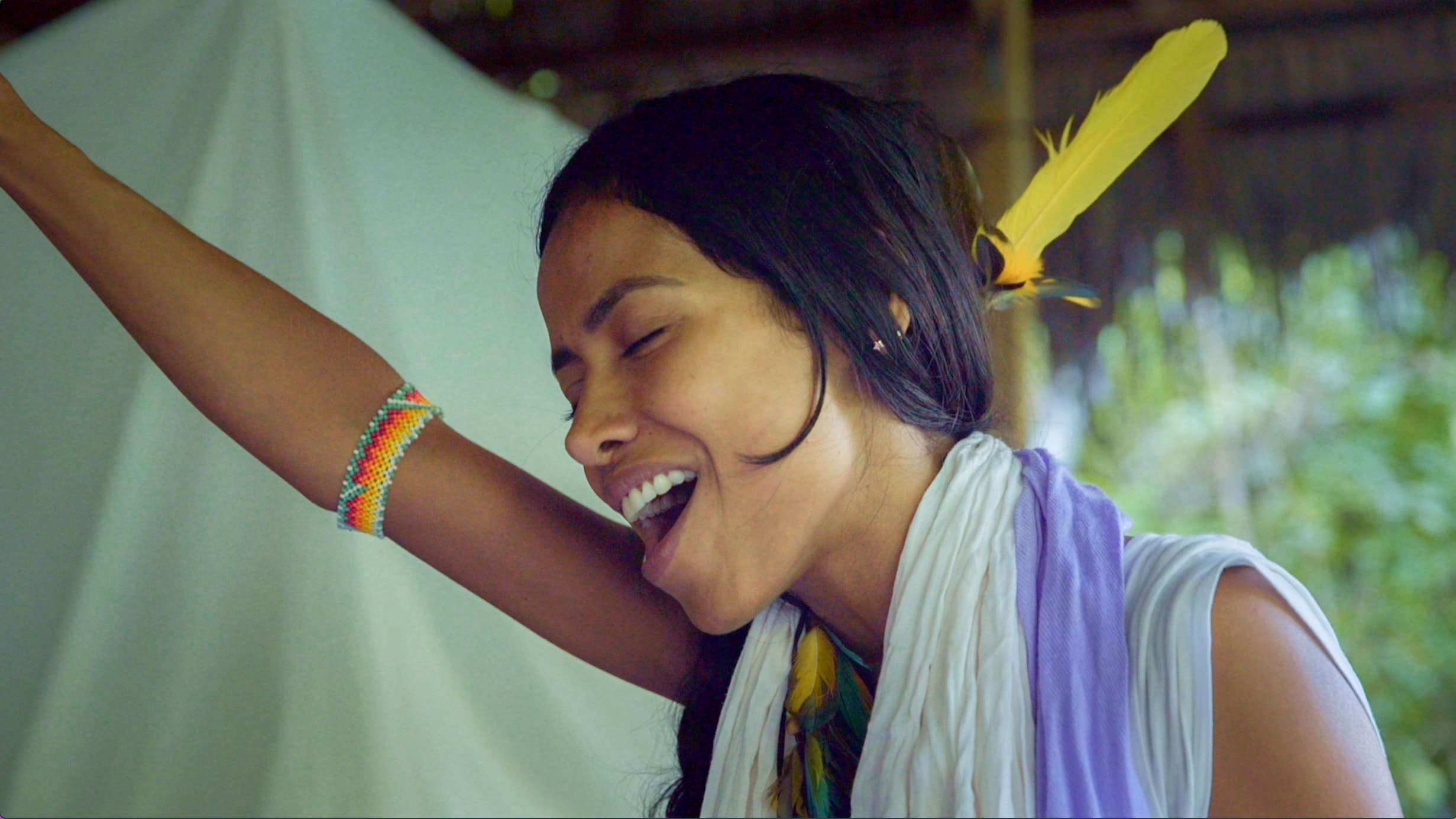 Tatiana laughing during a gathering in the forest